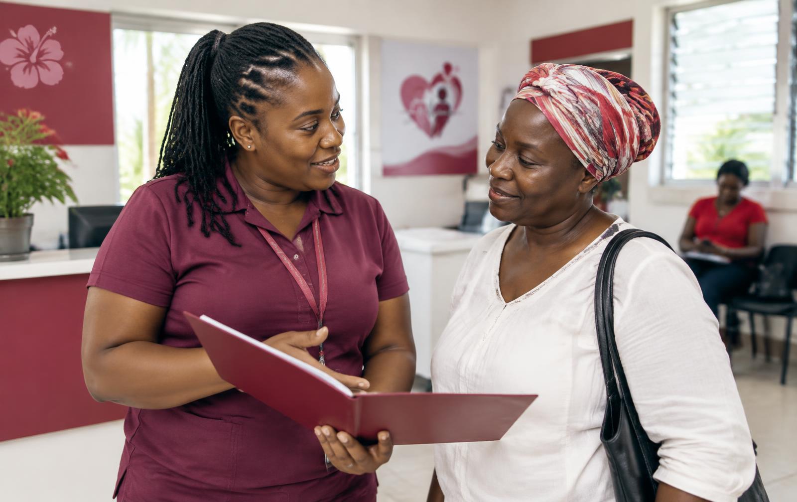 Patient navigator speaking with a patient in a clinic